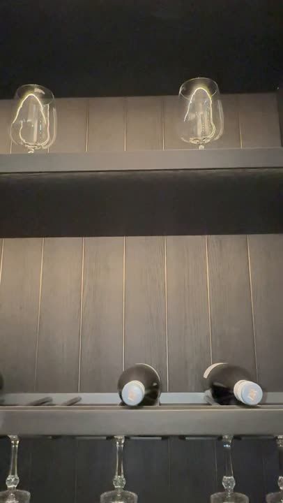 Tall cabinet run with internal lighting and glass shelves